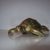 Golden brass ashtray has a turtle-shaped
