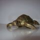 Golden brass ashtray has a turtle-shaped