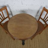 oak tray table with cast iron legs and pair of bistro chairs