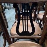 Set of 6 vintage curved wooden chairs, adorned with an elegant black lyre-shaped backrest.