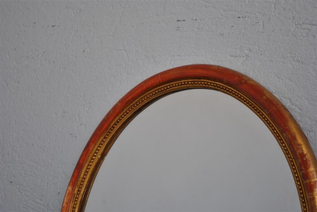 Golden stucco oval mirror