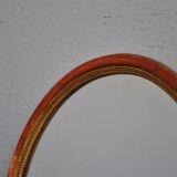 Golden stucco oval mirror