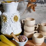 Six vintage potter's ceramic cups with vanilla enamel