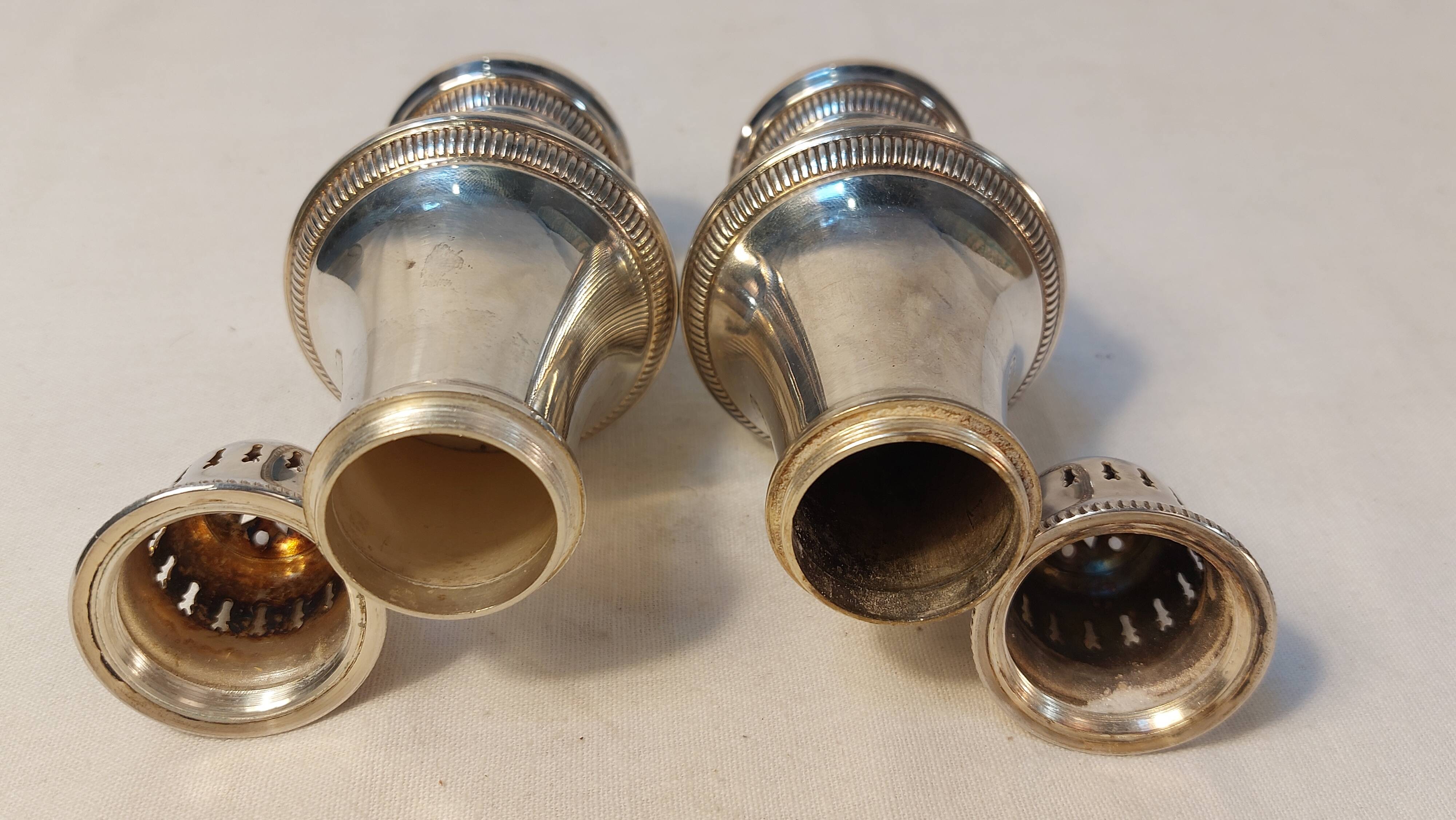 Set of two silver metal sprinklers