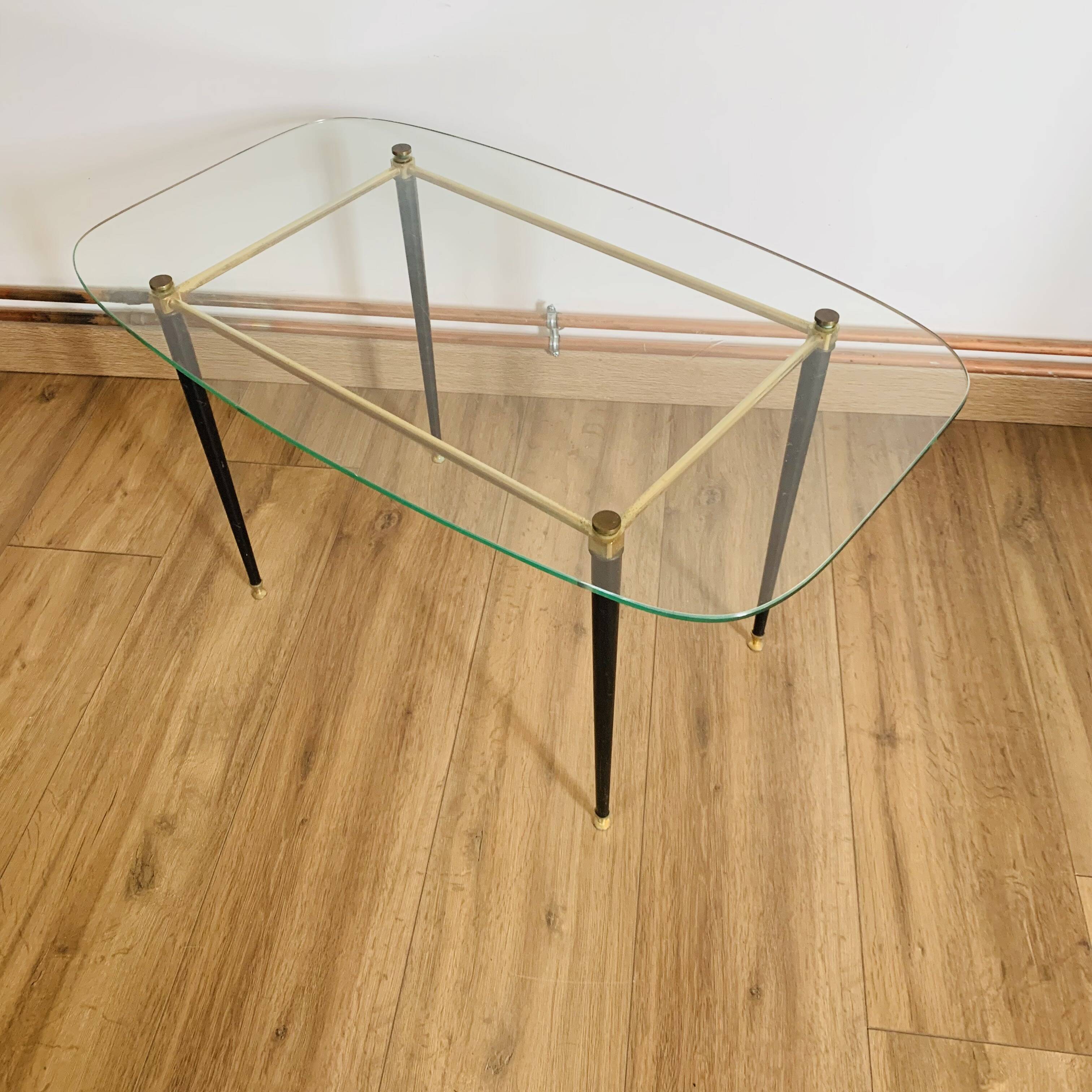 Coffee table from the 50s/60s, glass, brass, black metal.