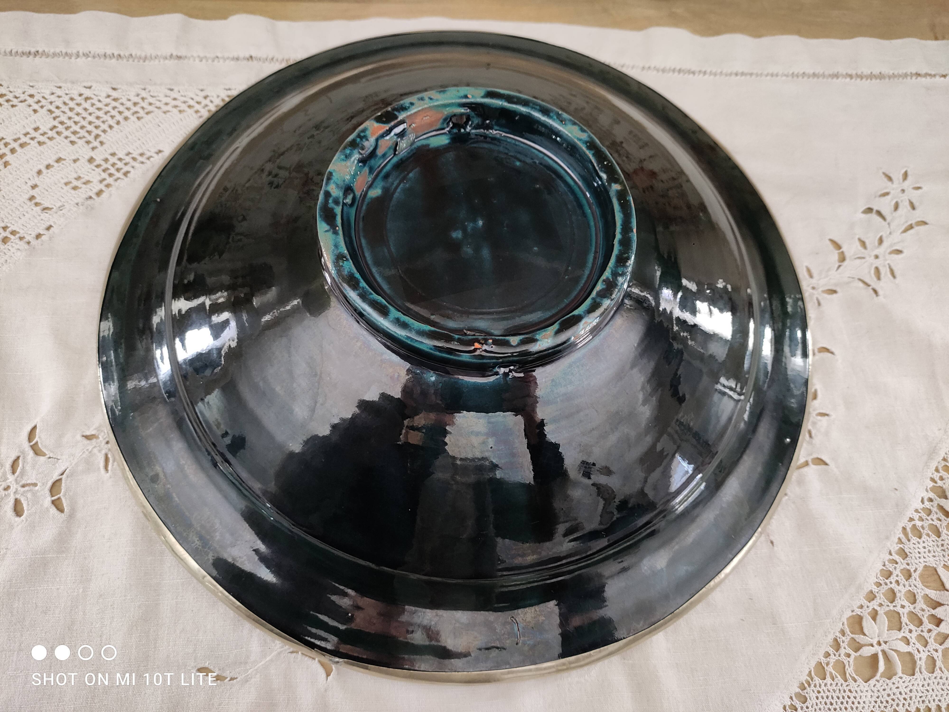 Round oriental hollow dish in deep green ceramic and silver colored metal