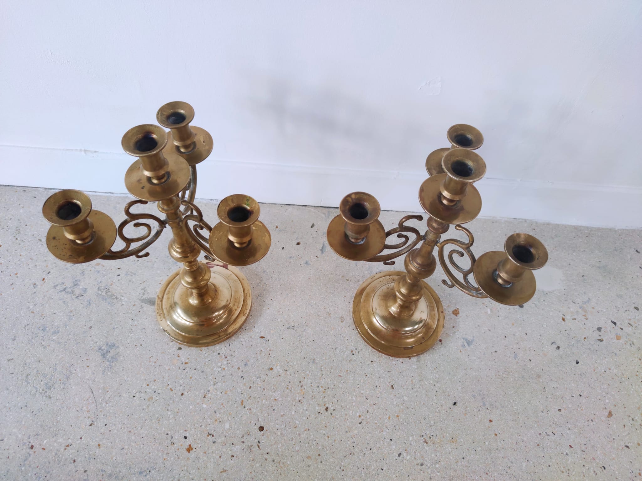 Pair of four-light candle holders in gilded brass