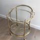 Round brass rolling table attributed to Maison Jansen