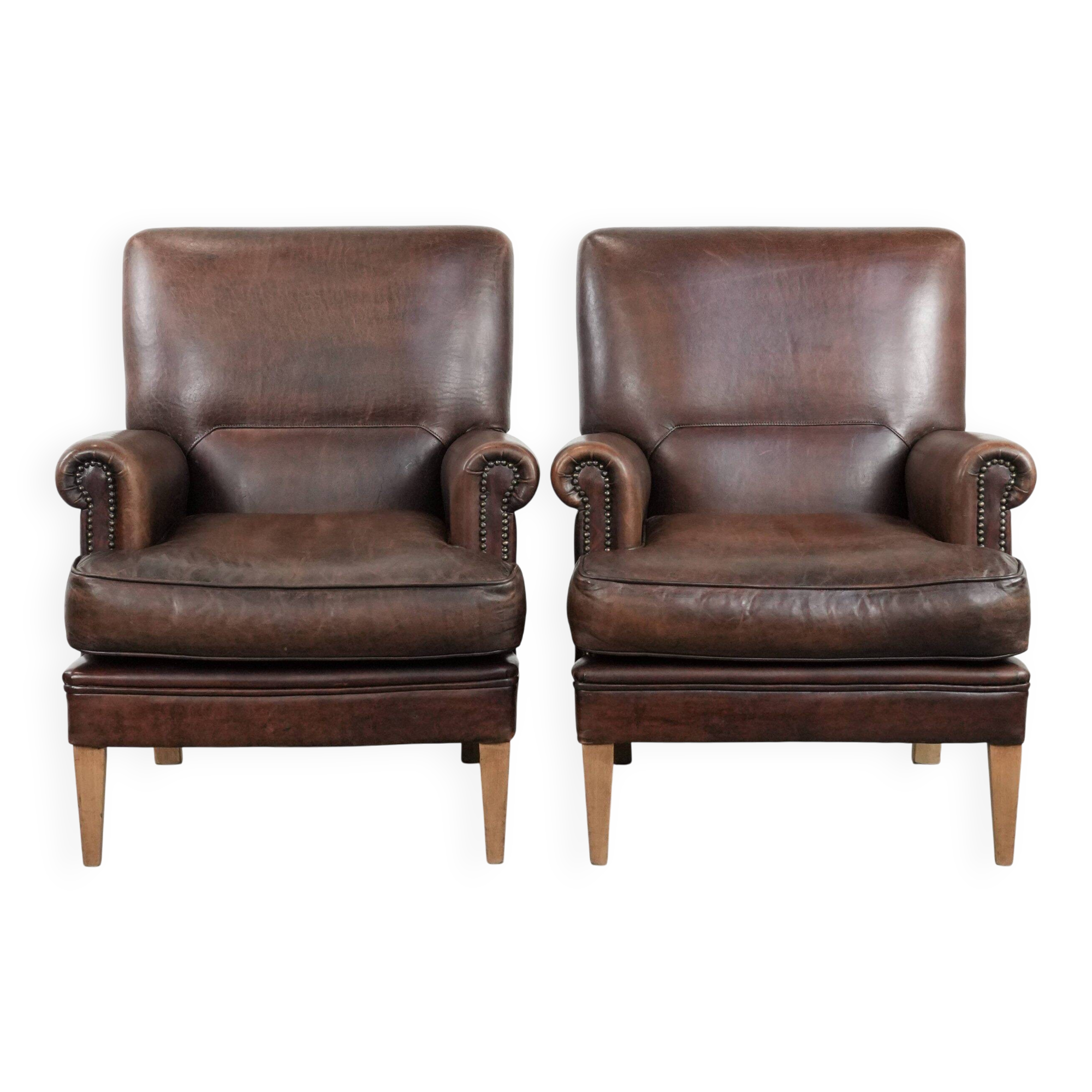 Set of two characterful sheepskin armchairs with a beautiful deep colour