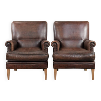 Set of two characterful sheepskin armchairs with a beautiful deep colour