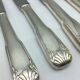 12 silver metal knives.