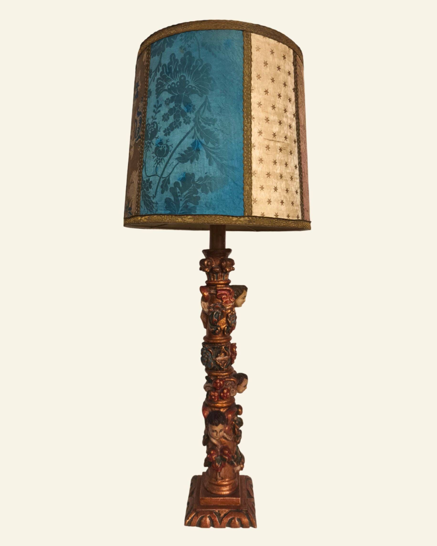 Renaissance table lamp in polychrome carved wood with cherubs.