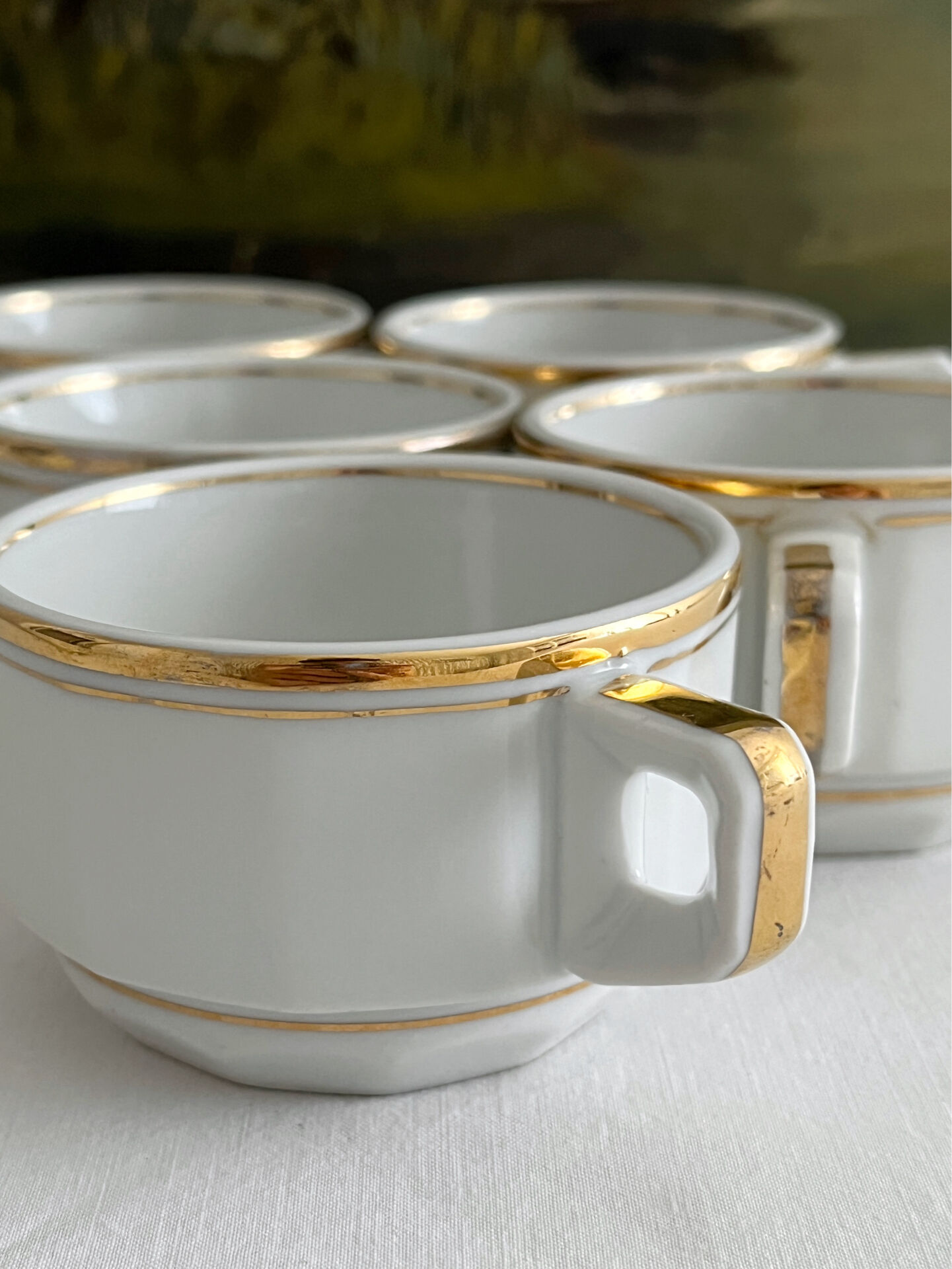 5 vintage porcelain bistro coffee cups from Paris with gold trim.