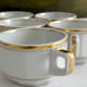 5 vintage porcelain bistro coffee cups from Paris with gold trim.