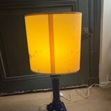 Corinthian column lamp base in blue with a lampshade of dried flowers.