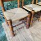 Set of 4 solid wood chairs with straw seats.