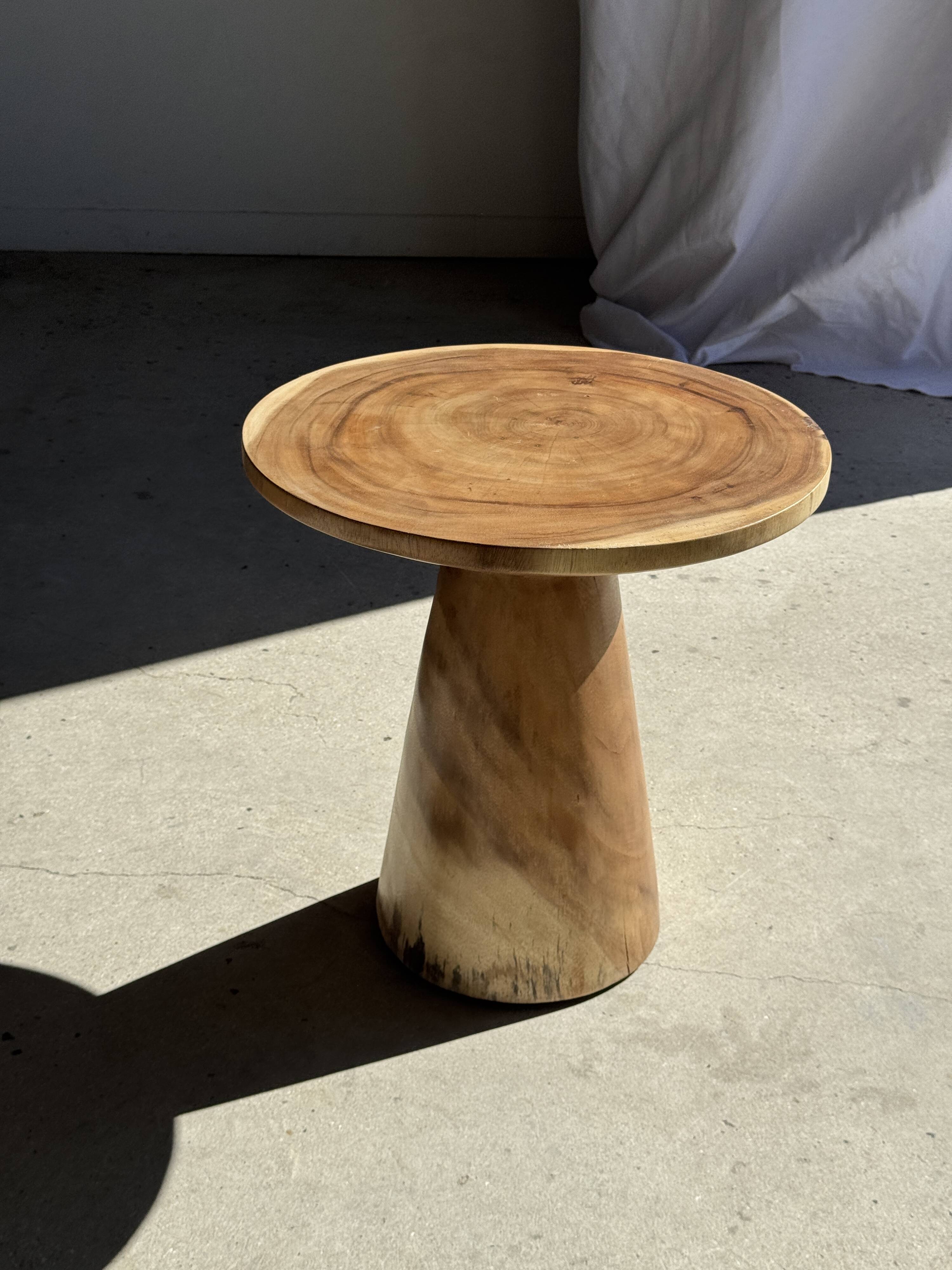 Natural solid suar side table (monoxyle) with a minimal conical base.