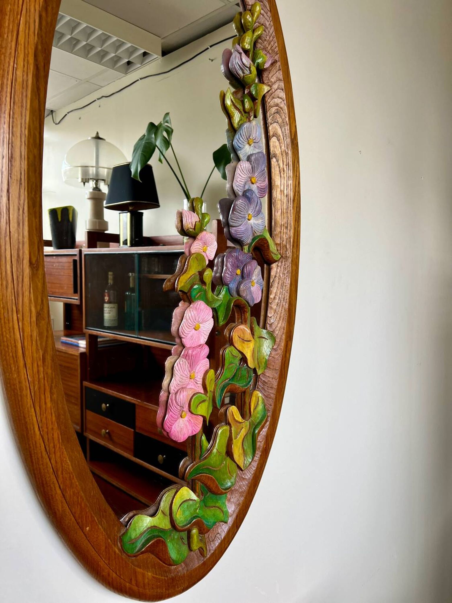 Carved wooden mirror with flower decorations.