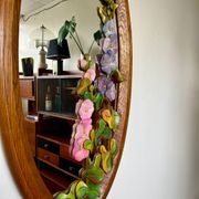 Carved wooden mirror with flower decorations.