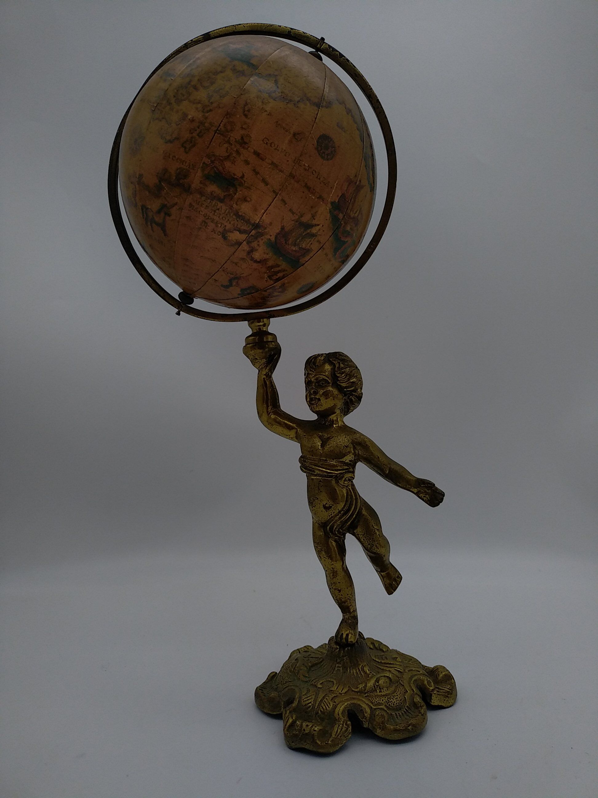 Cherub or putti carrying a globe