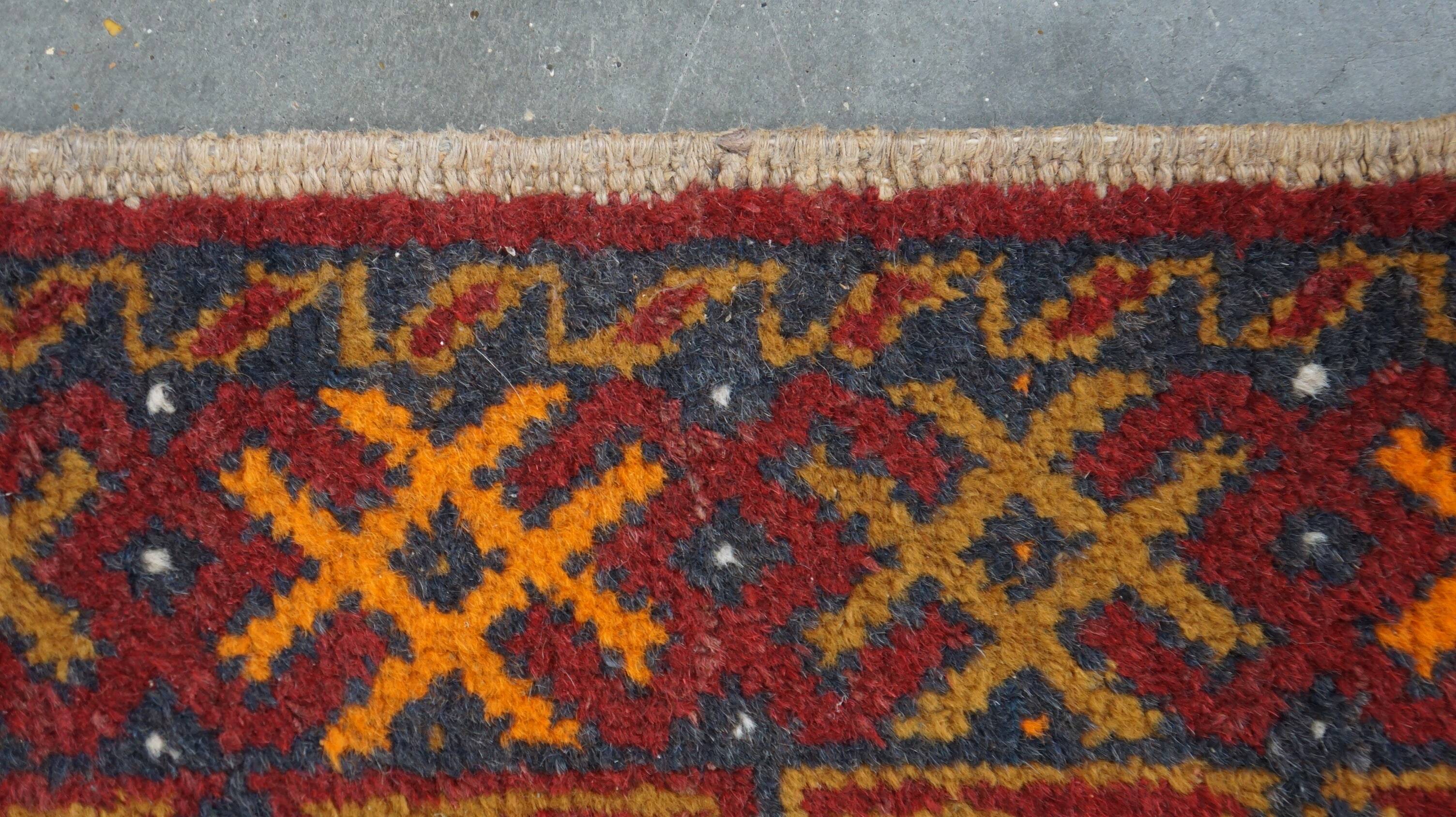 Antique oriental rug featuring orange details 135x81cm