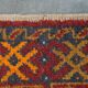 Antique oriental rug featuring orange details 135x81cm