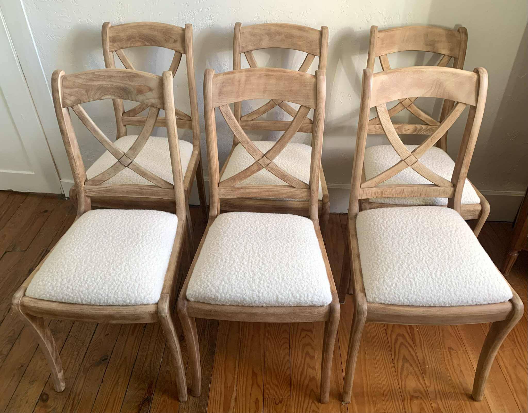 Set of 6 cross-back chairs in solid wood, with white boucle seats.