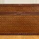 Beautiful vintage Chinese trunk in wicker, black and gold lacquered wood, and brass.