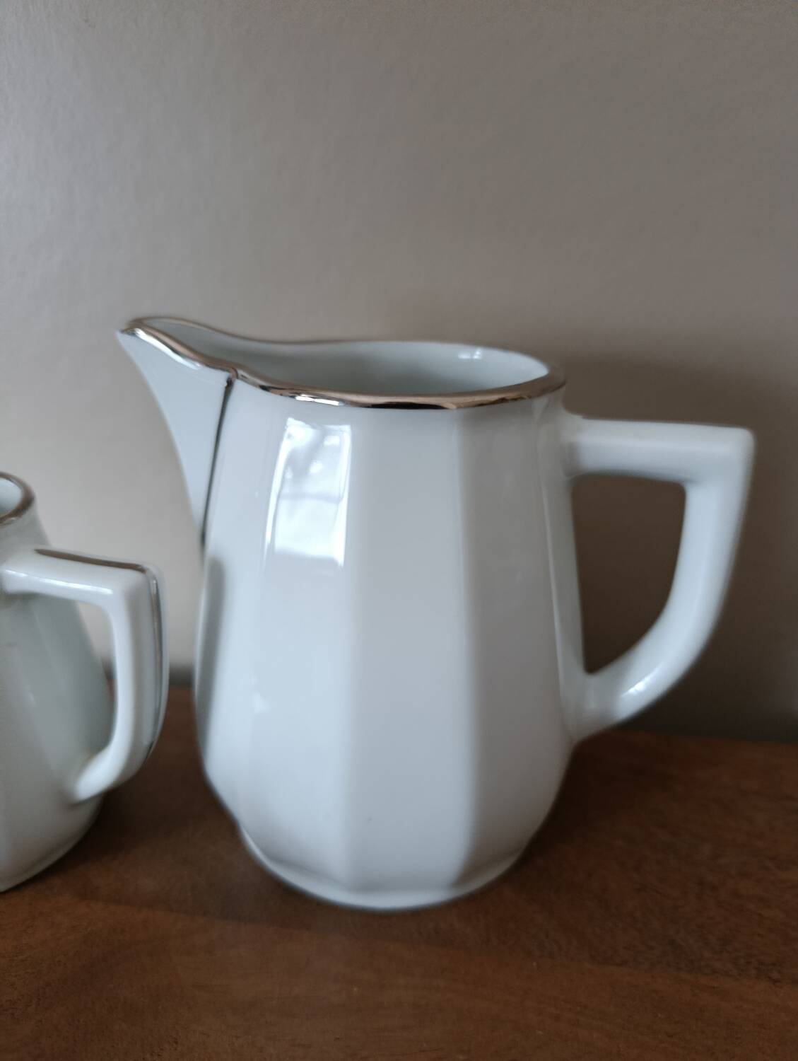 2 white porcelain milk jugs with platinum trim, Flora by Apilco.