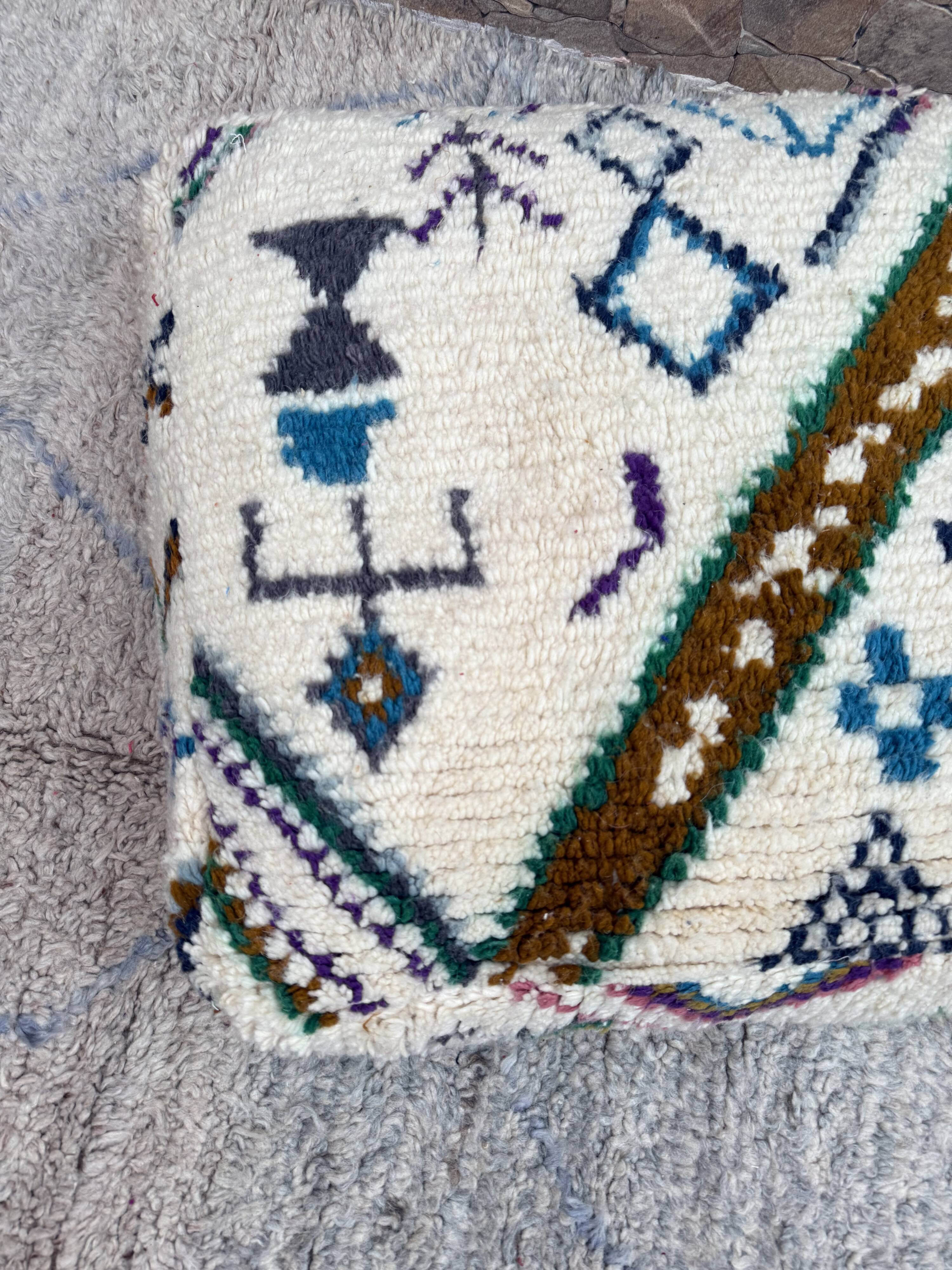 Berber floor pouf: Handwoven Moroccan wool cushion.