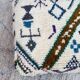 Berber floor pouf: Handwoven Moroccan wool cushion.