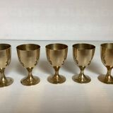 Five brass egg cups