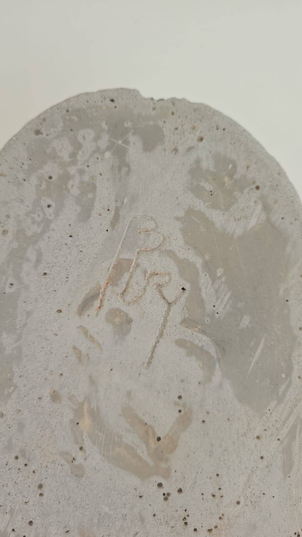 Greek god statue in stone with a marble base.