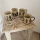 Set of 4 ceramic mugs, glazed stoneware, assorted vintage designs.