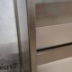 Ivory-colored and matte gold anodized aluminum display bookcase
