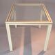 White lacquered side table by Pierre Vandel with gold brass.