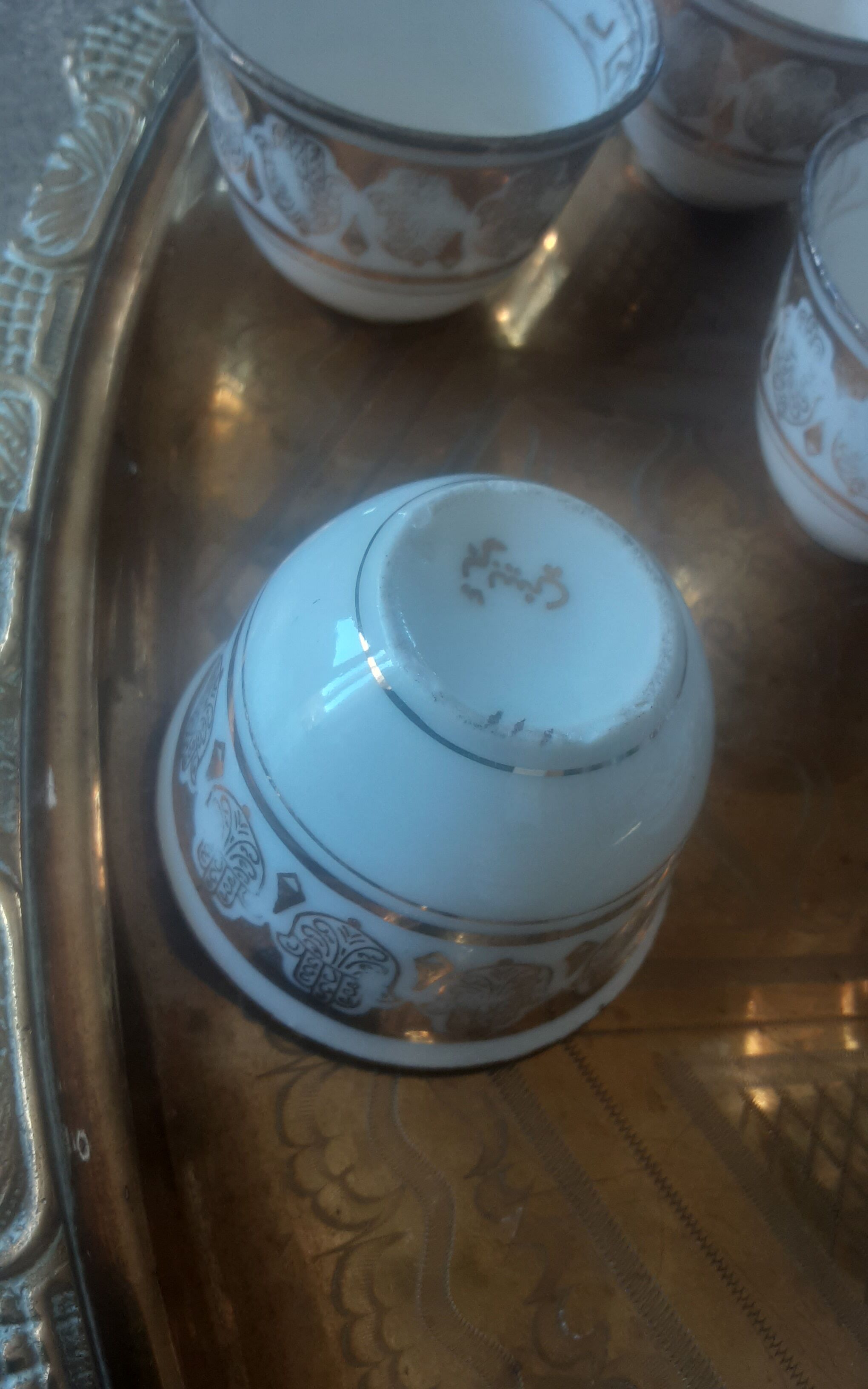 Old service porcelain brass cups