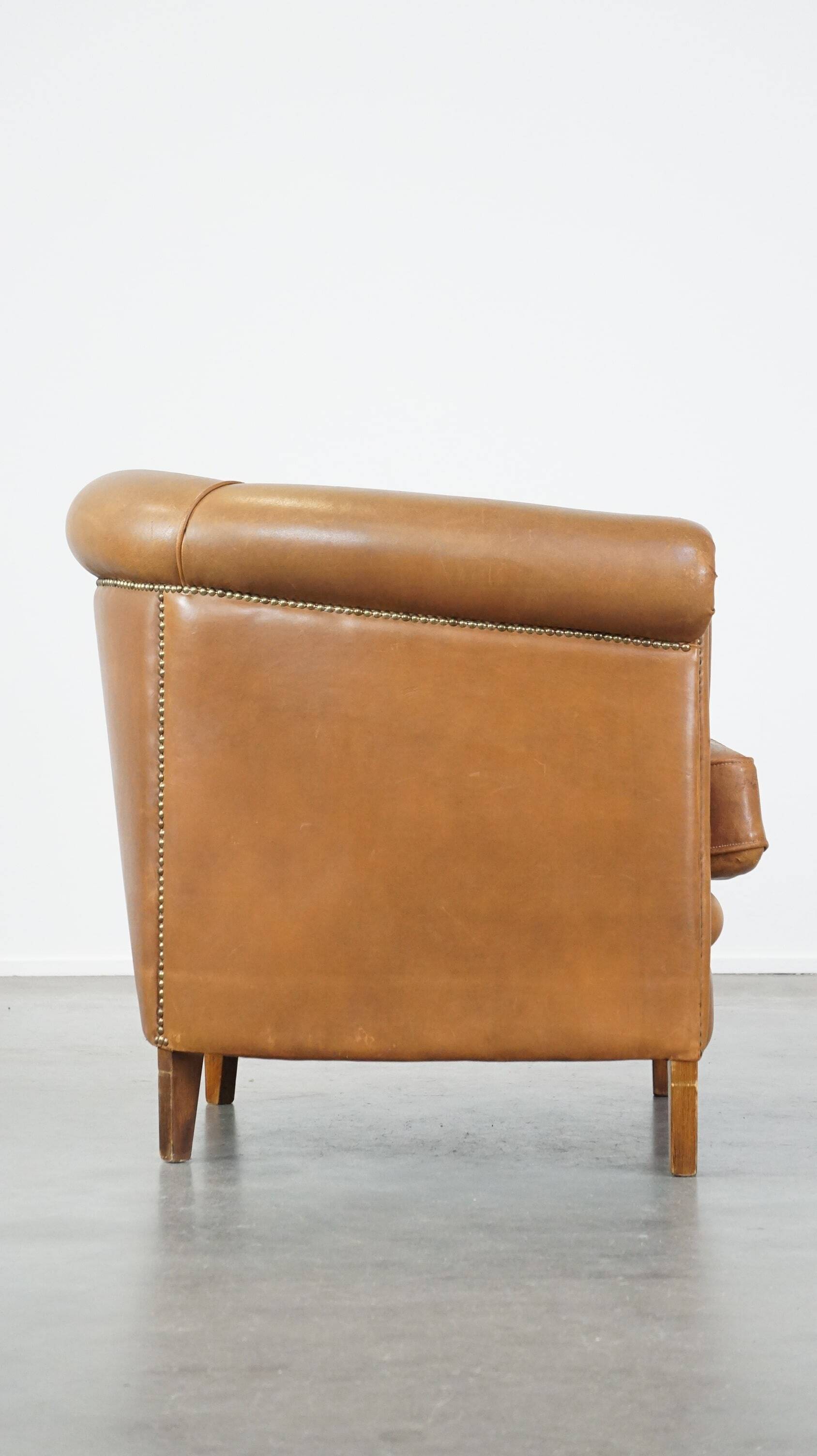 Sheep leather club chair in neutral cognac colour and in good condition