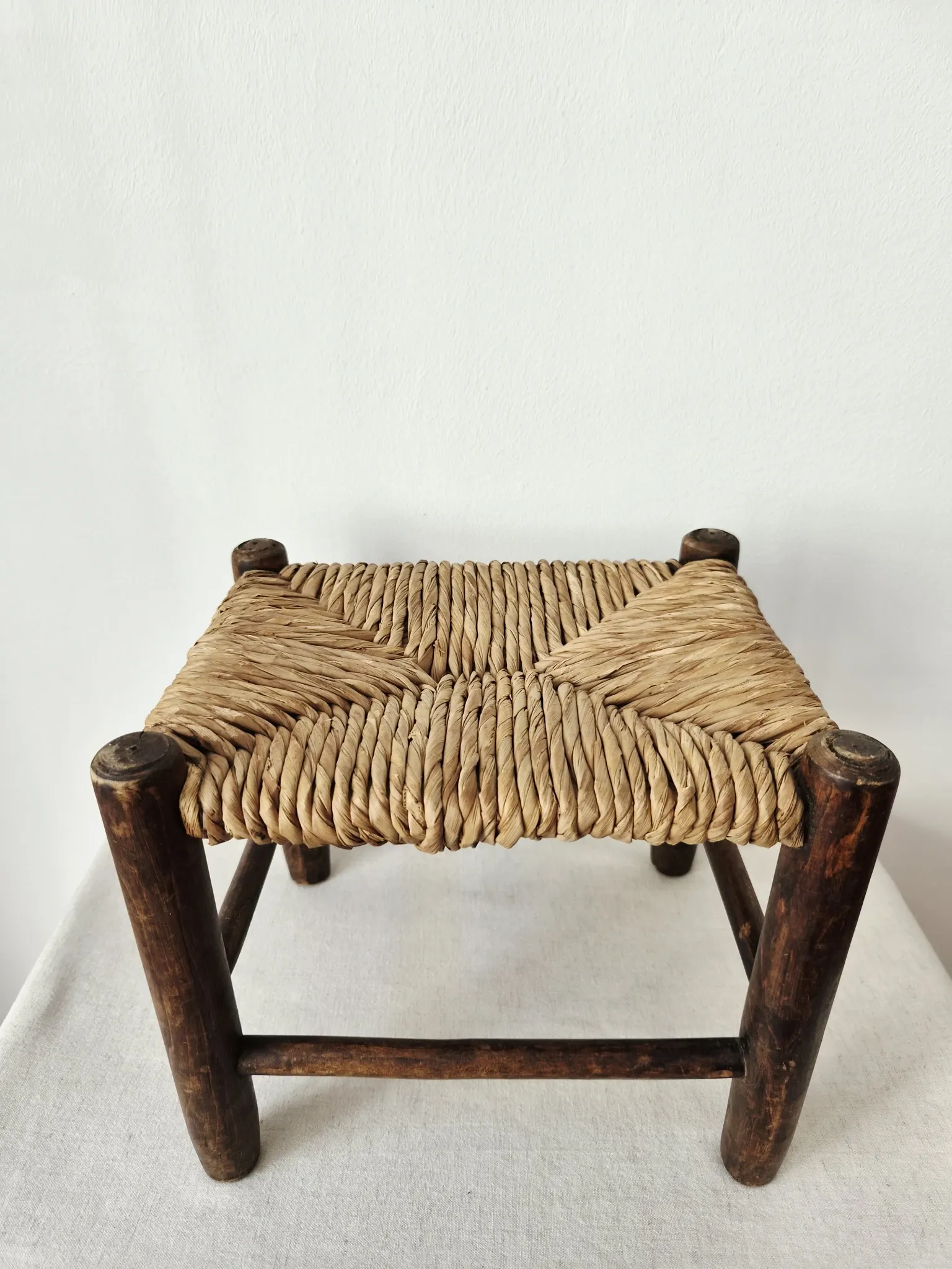Small rustic vintage wooden and straw stool -