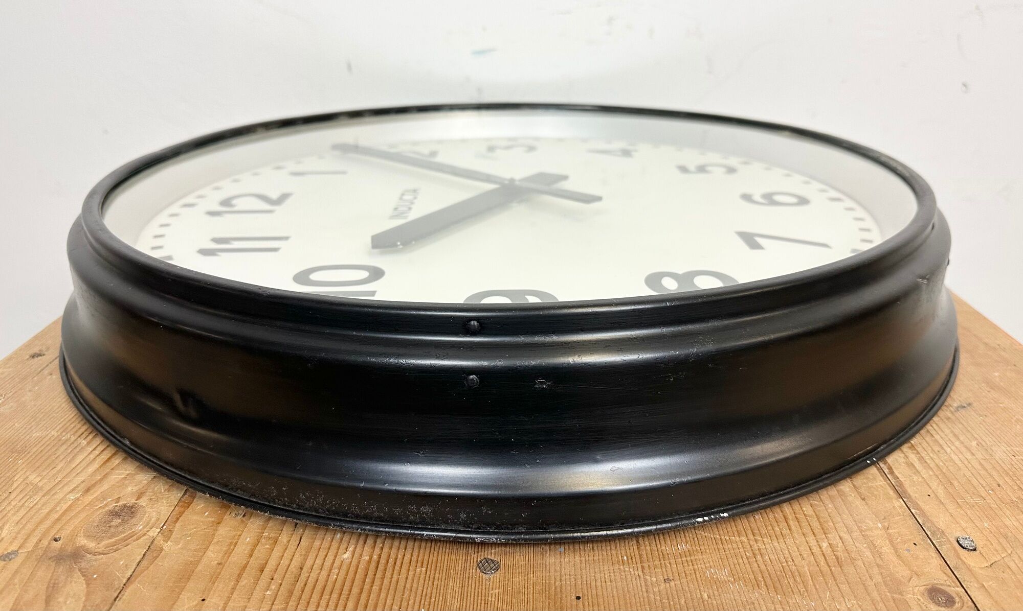 Black swiss industrial wall clock from inducta, 1960s