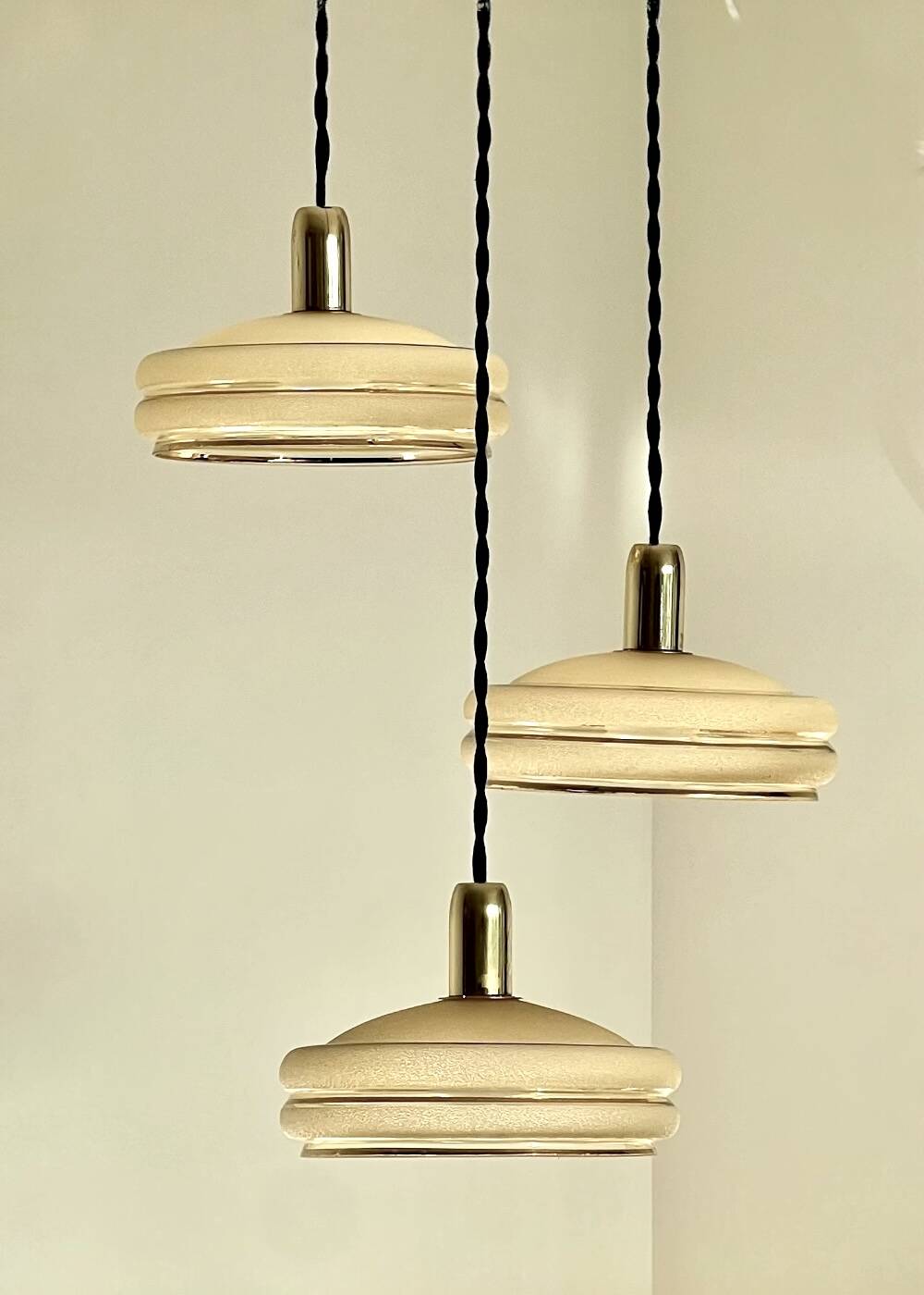 Triple cascade pendant light with vintage frosted glass globes and gold finish