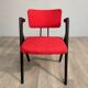 Red fabric chair with black base