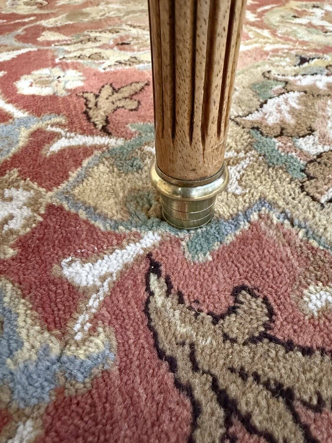 Round dining table with leather top in Louis XVI style.