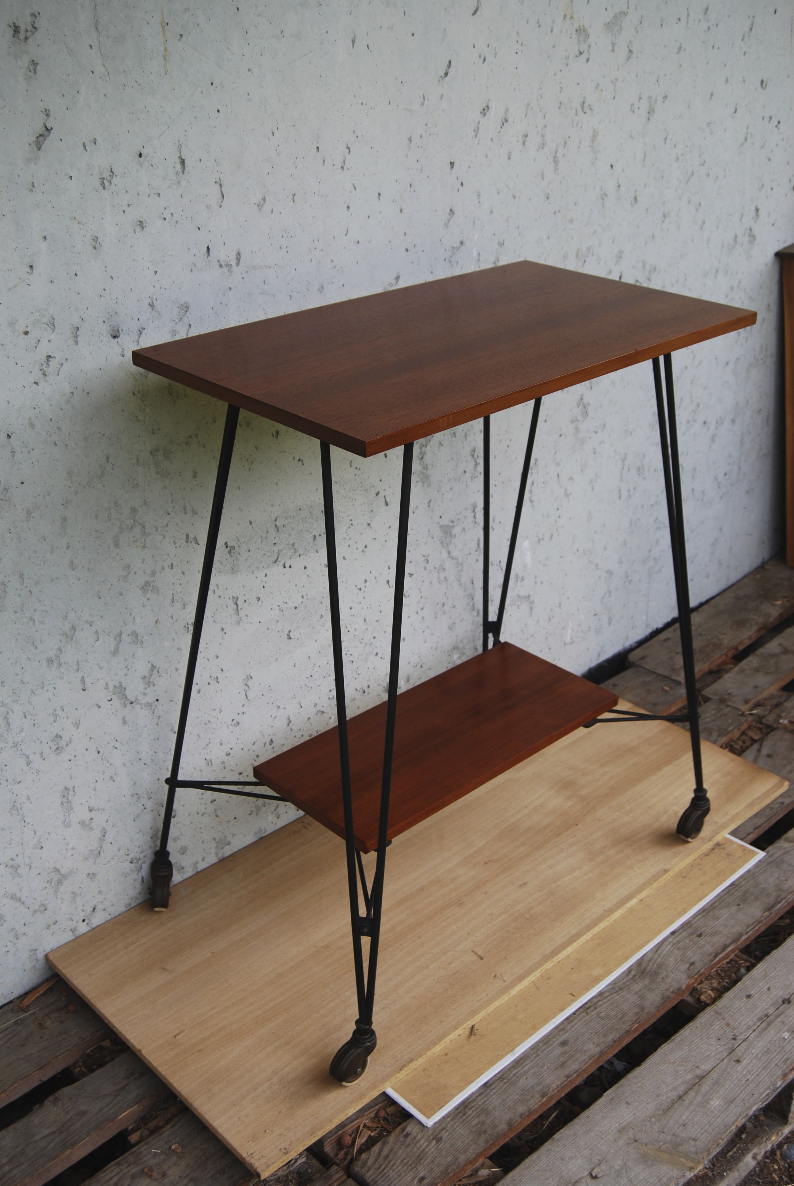 Tv furniture, a table with teak wheels and Scandinavian-style metal.