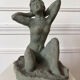 Sculpture of a naked woman titled "Youth" in terracotta.