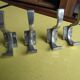 Set of four aluminium coat hooks from the 1950s.