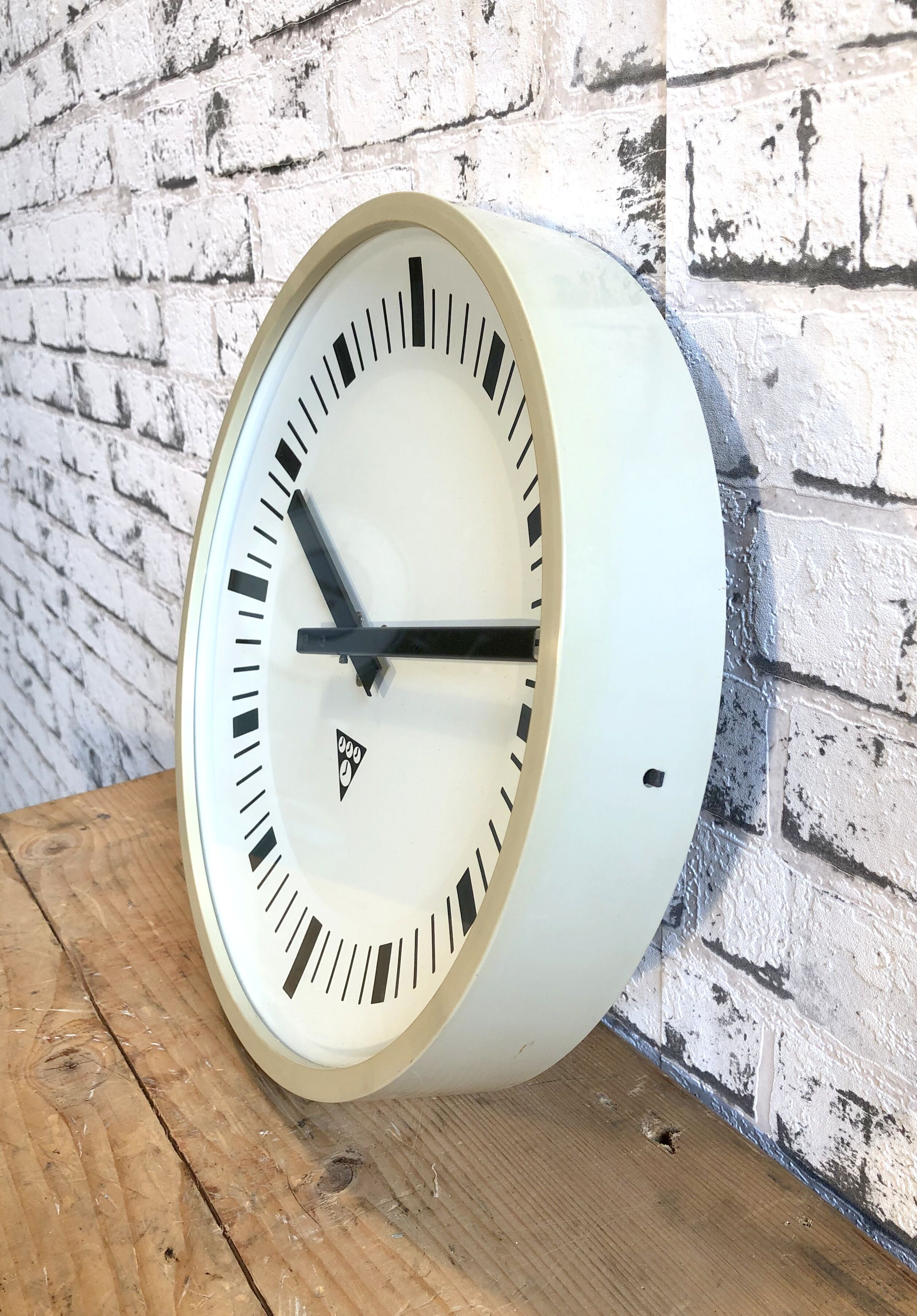 Beige industrial bakelite wall clock from Pragotron, 1970s