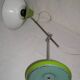Green desk lamp with an arm from the 1970s.