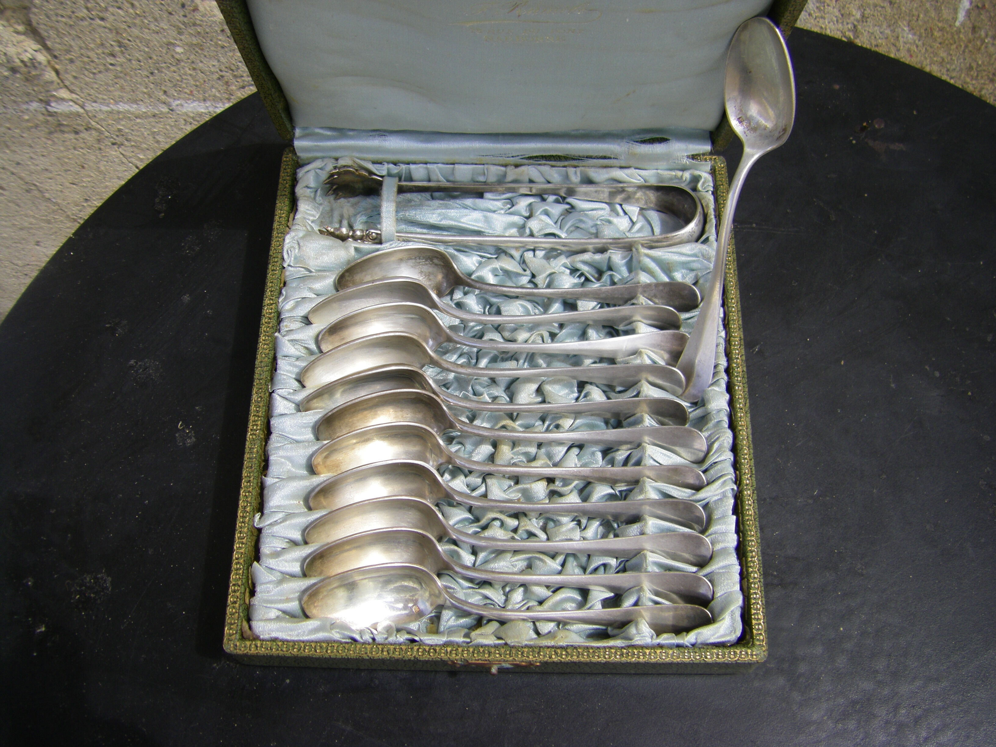 Set of twelve teaspoons and a sugar tongs
