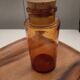 Amber pharmacy bottle made of old bubbled glass